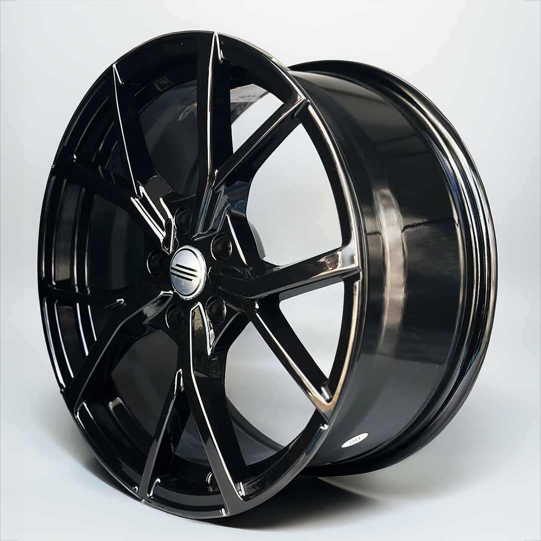 Black alloy wheel on a white background